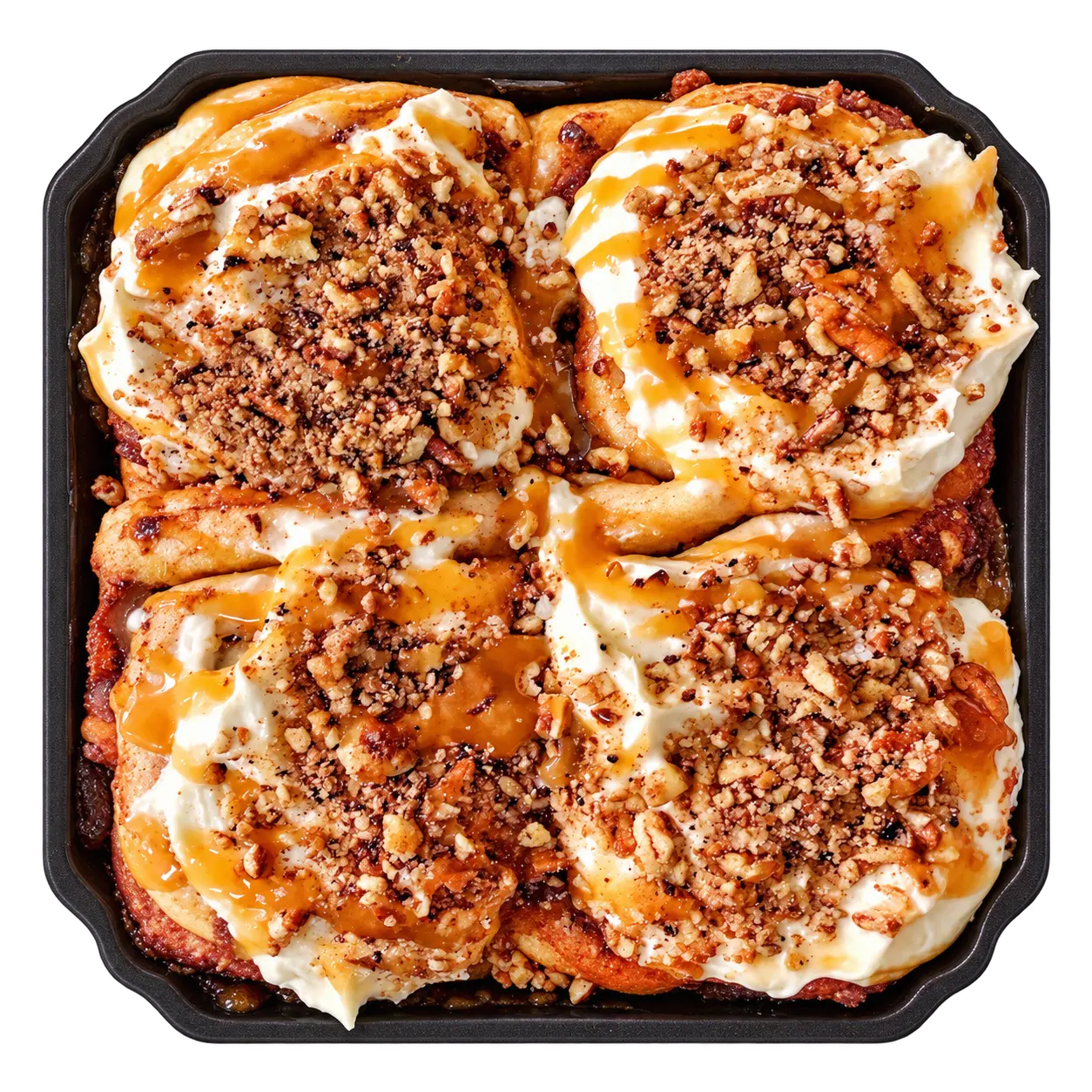 Overhead view of four Pecan Praline cinnamon rolls in a baking tray